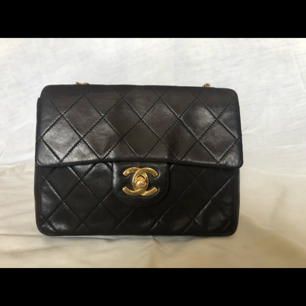 Authentic Vintage Chanel mini flap shoulder bag in black lambskin.